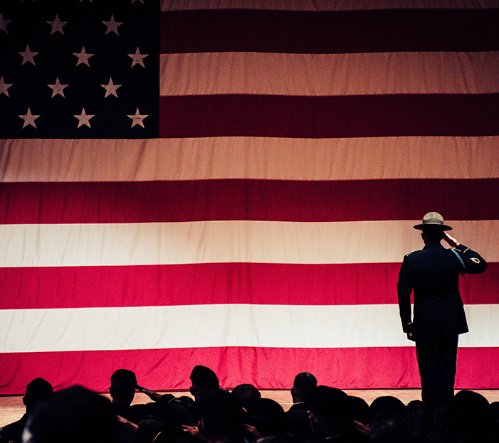 military soluting the american flag